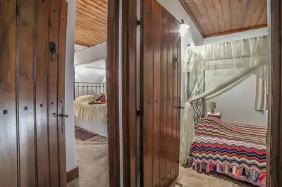a bedroom with a bed and a bedroom with wooden walls at Lofou Traditional House in Lofou