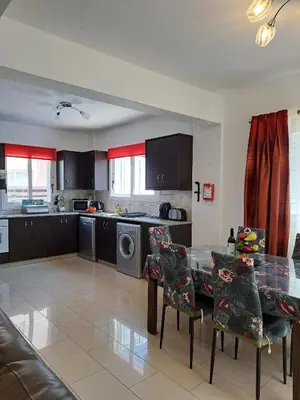 a kitchen with a table and a kitchen with a washing machine at Anasta villa in Protaras