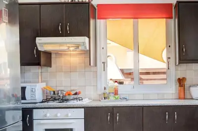 a kitchen with a stove top oven next to a window at Anasta villa in Protaras
