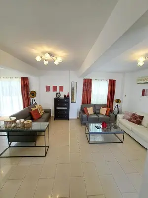 a large living room with couches and tables at Anasta villa in Protaras
