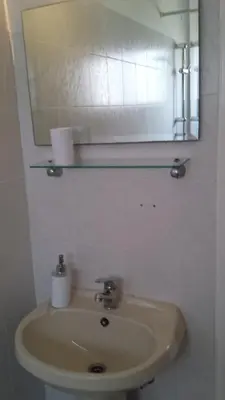 a bathroom with a sink with a mirror and a mirror at LIRA in Larnaka