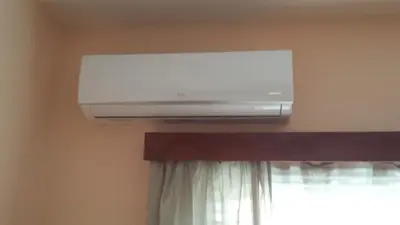 a air conditioner on the wall above a window at LIRA in Larnaka