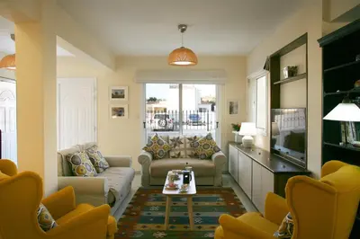a living room with a couch and a table at Villa Carmel in Ayia Napa