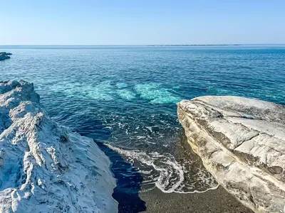 a view of the ocean from a rocky shore at Cyprus Villages - Hotel & Restaurant - Central Location - Bed & Breakfast With Access To Pool And Stunning Views in Tochni