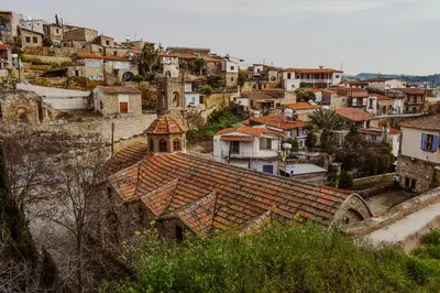 an old house with a tile roof in a village at Cyprus Villages - Hotel & Restaurant - Central Location - Bed & Breakfast With Access To Pool And Stunning Views in Tochni