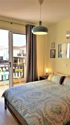 a bedroom with a large bed and a balcony at Palm Paradise Villa in Ayia Napa