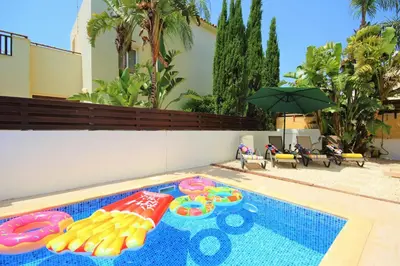 a swimming pool with a inflatable toy in it at Palm Paradise Villa in Ayia Napa