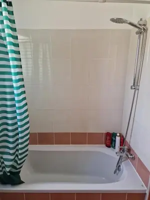 a bathtub in a bathroom with a shower at Oceania Bay Village in Pyla