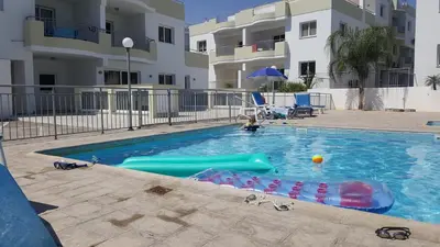 a child playing in a swimming pool in a apartment at Oceania Bay Village in Pyla
