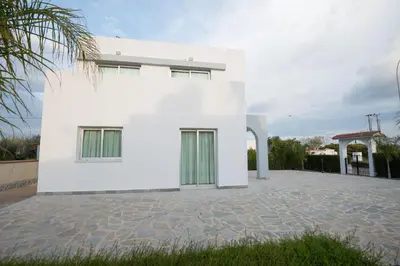 a white house with a courtyard at Makronissos Beach Villas in Ayia Napa