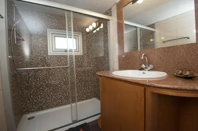 a bathroom with a sink and a shower at Makronissos Beach Villas in Ayia Napa