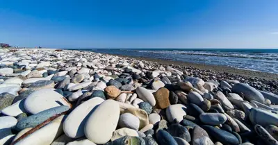 a large group of rocks on a beach at Blue Bay Beach House in Larnaka