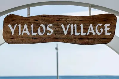 a wooden sign that reads vlasquez village at Blue Bay Beach House in Larnaka