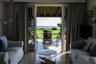 a living room with a view of the ocean at Blue Bay Beach House in Larnaka