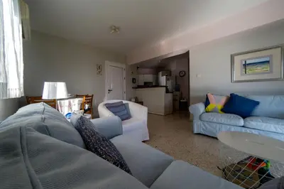 a living room with a couch and a table at Blue Bay Beach House in Larnaka