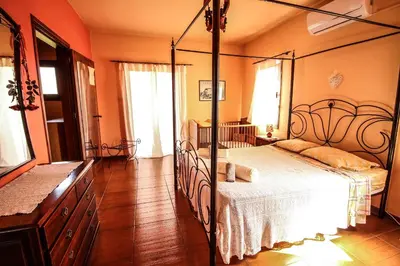 a bedroom with a bed with a metal frame at Rustic House in Xylophaghou