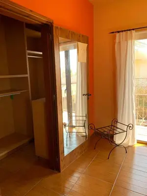 a mirror in the corner of a room with a window at Rustic House in Xylophaghou