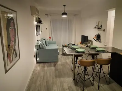a living room with a table with chairs and a couch at Yippee!(Perfect Location) in Larnaka