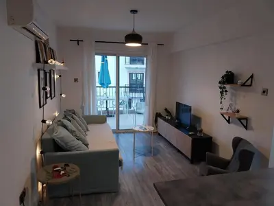 a living room with a couch and a television at Yippee!(Perfect Location) in Larnaka