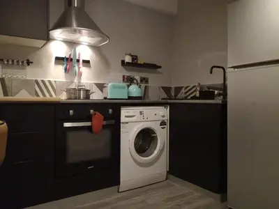 a kitchen with a washing machine in a kitchen at Yippee!(Perfect Location) in Larnaka