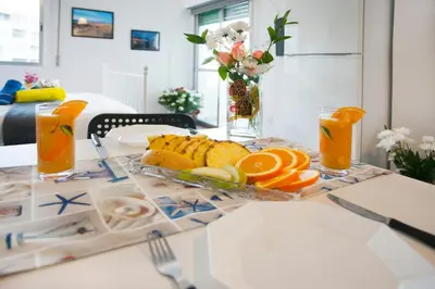 a table with a plate of fruit and orange slices at Poseidon Boutique Apartment 2 in Limassol