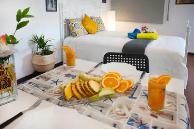 a tray of fruit on a table with a bed at Poseidon Boutique Apartment 2 in Limassol