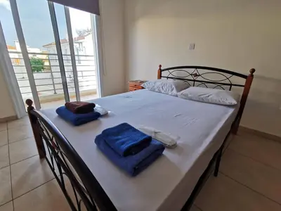 a bed with two towels on top of it at BG04 Mythical Sands in Paralimni