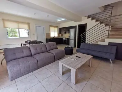 a living room with a couch and a table at BG04 Mythical Sands in Paralimni