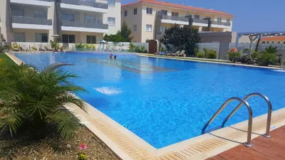 a large blue swimming pool in front of a building at BG04 Mythical Sands in Paralimni