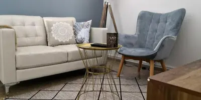 a living room with a couch and a chair at Cozy Getaway in Nicosia in Yukarı Lakatamya