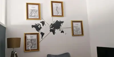 a wall with framed maps of the world on it at Cozy Getaway in Nicosia in Yukarı Lakatamya