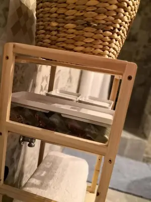 a wooden stool with a basket on top of it at Cozy Getaway in Nicosia in Yukarı Lakatamya