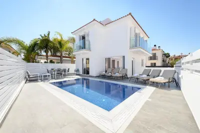 a villa with a swimming pool and a house at Villa Elaine in Paralimni