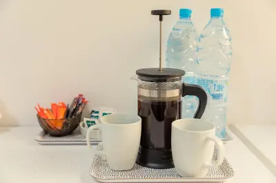 a coffee maker sitting on a counter with two cups at Andriana City Centre Flat in Larnaka