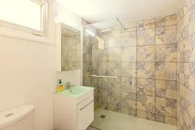 a bathroom with a shower and a toilet and a sink at Andriana City Centre Flat in Larnaka