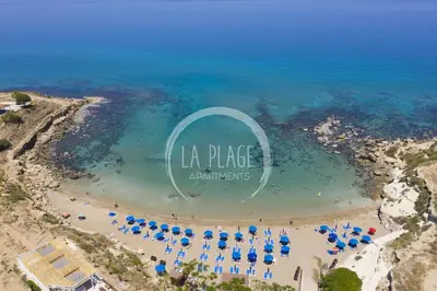 an aerial view of a beach with umbrellas and the sign at ♥ Sunny&Cozy Family Apartment ★ Walk to the Beach☼ in Paralimni