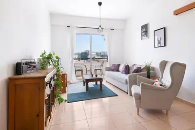 a living room with a couch and a table at Welcome! Perfect Location-City Center in Larnaka