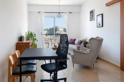 a living room with a table and chairs and a couch at Welcome! Perfect Location-City Center in Larnaka