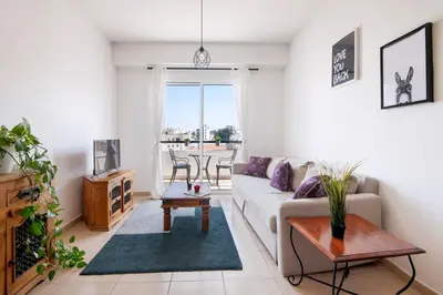 a living room with a couch and a table at Welcome! Perfect Location-City Center in Larnaka