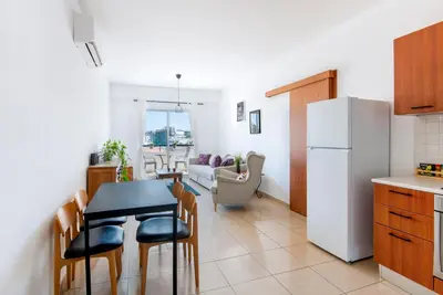 a kitchen and dining room with a table and a refrigerator at Welcome! Perfect Location-City Center in Larnaka