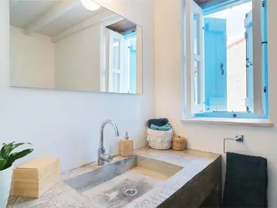 a bathroom with a sink and a window at Villa Avgoustis in Pachna