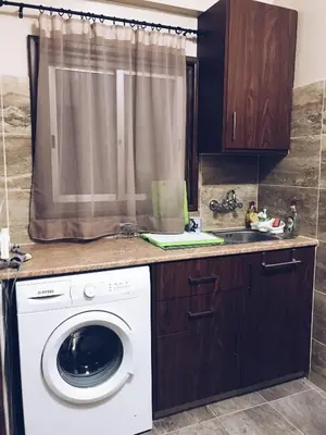 a kitchen with a washing machine and a sink at Studio in heart of Limassol in Limassol