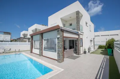 a villa with a swimming pool and a house at Villa Anemoni 8 in Protaras