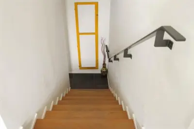 a hallway with a staircase with a door and a window at Strovolos Value Suites in Strovolos