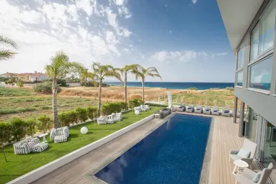a view of a swimming pool and the ocean from a house at Villa Chana in Protaras