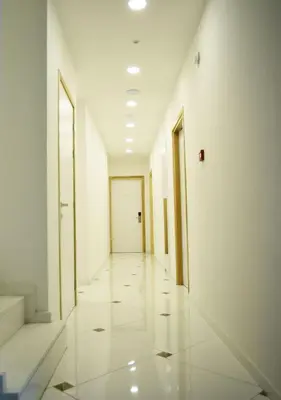 an empty hallway with white walls and a door at Hai Hotel in Larnaka