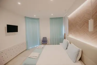 a hotel room with a bed and a tv at Hai Hotel in Larnaka