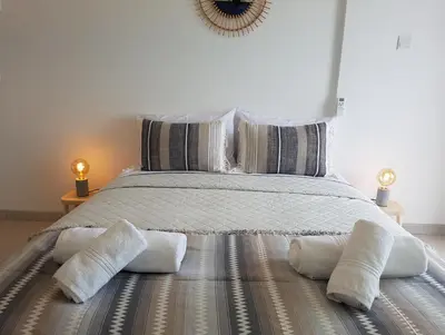 a bedroom with a large bed with two pillows at Larnaka Seaview Luxury Suites in Larnaka