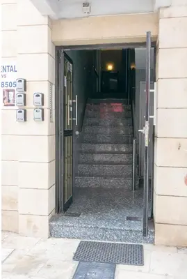 a stairway leading into a building with a door at Larnaka Seaview Luxury Suites in Larnaka