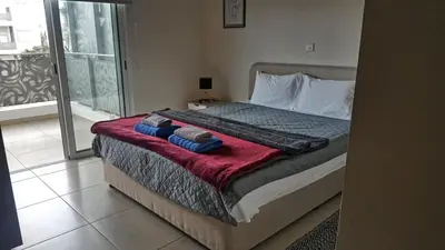 a bedroom with a bed with two pillows on it at Mythical Sands Luxury Apartment in Paralimni